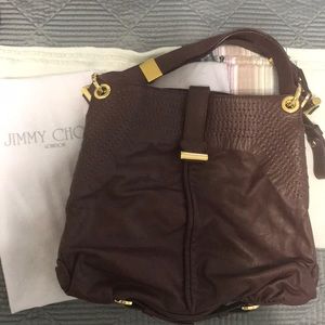 Jimmy Choo brownish burgundy shoulder handbag.